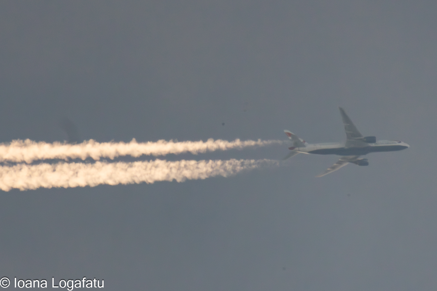 Airplane gliding through a vibrant blue sky